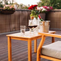 roses-wine-glass-ice-bucket-wooden-table-restaurant (1)